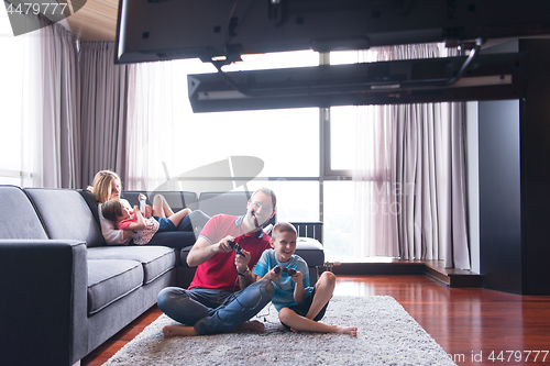 Image of Happy family playing a video game