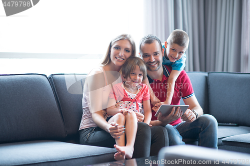 Image of happy young couple spending time with kids