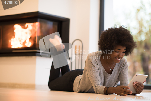 Image of black women using tablet computer on the floor