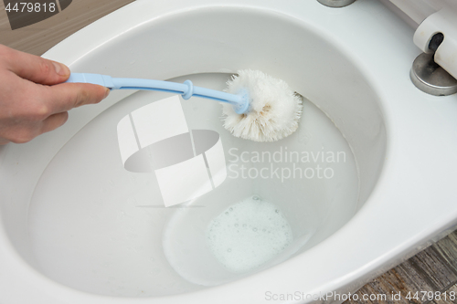 Image of Washing inside the toilet bowl with a disinfectant