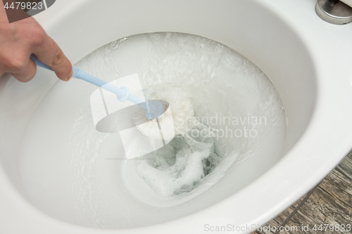 Image of Flush water after cleaning the toilet brush