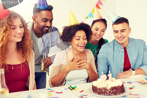 Image of team greeting colleague at office birthday party