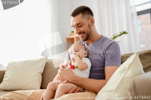 Image of happy father with little baby daughter at home