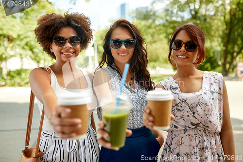 Image of happy women or friends with drinks at summer park