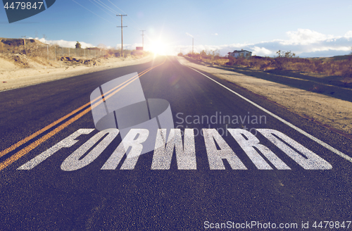 Image of close up of word forward on suburban asphalt road