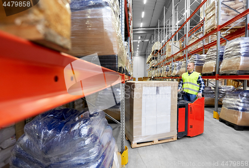 Image of loader operating forklift at warehouse