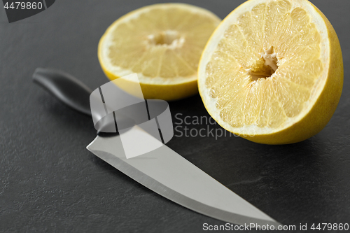 Image of close up of chopped lemon and knife on table