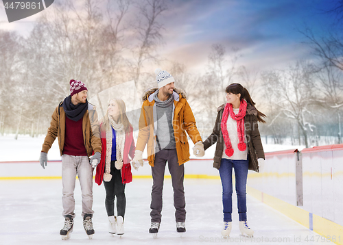 Image of happy friends on outdoor skating rink