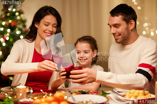 Image of happy family having christmas dinner at home