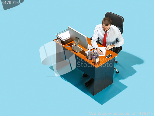 Image of Shot from above of a stylish business man working on a laptop.