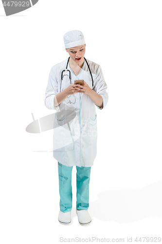 Image of Beautiful young woman in white coat posing at studio. Full length studio shot isolated on white.