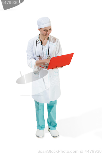 Image of Beautiful young woman in white coat posing at studio. Full length studio shot isolated on white.