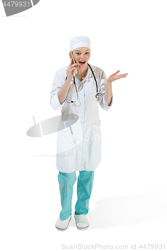 Image of Beautiful young woman in white coat posing at studio. Full length studio shot isolated on white.