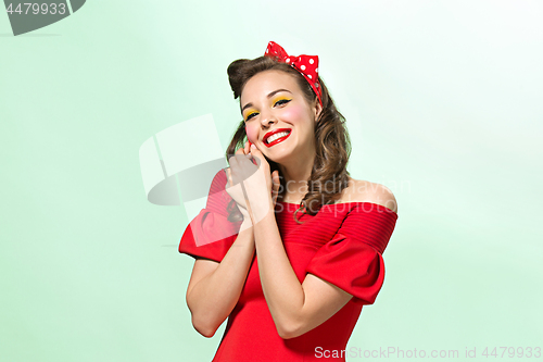 Image of Beautiful young woman with pinup make-up and hairstyle. Studio shot on white background