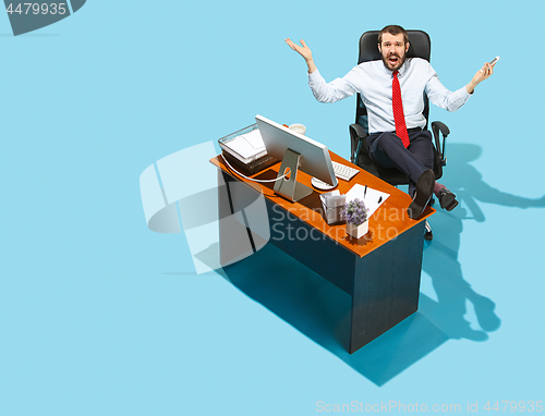 Image of Shot from above of a stylish business man working on a laptop.