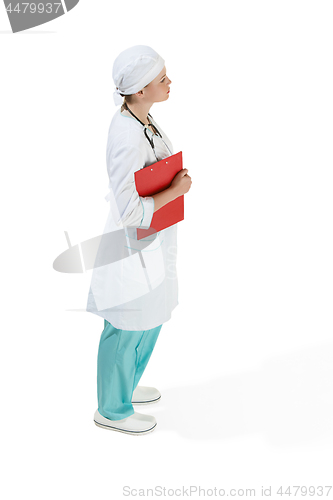 Image of Beautiful young woman in white coat posing at studio. Full length studio shot isolated on white.