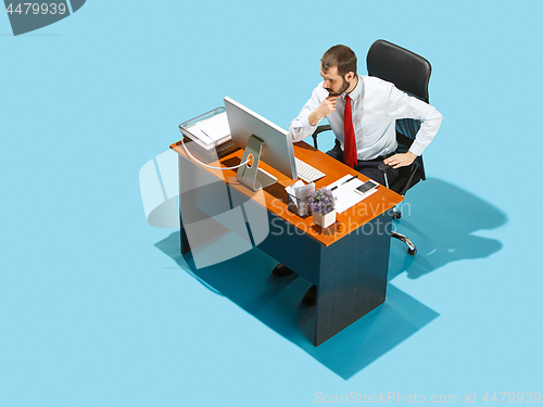 Image of Shot from above of a stylish business man working on a laptop.