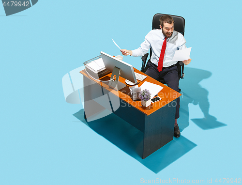 Image of Shot from above of a stylish business man working on a laptop.