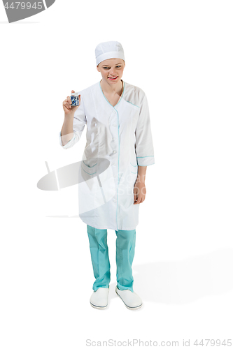 Image of Beautiful young woman in white coat posing at studio. Full length studio shot isolated on white.
