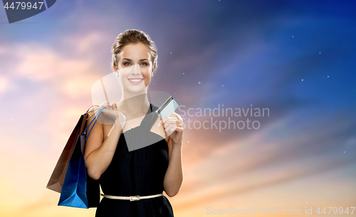 Image of woman with credit card and shopping bags