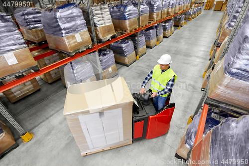 Image of loader operating forklift at warehouse