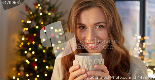 Image of happy woman with cup of tea or coffee on christmas