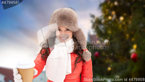 Image of woman with coffee over christmas tree in tallinn