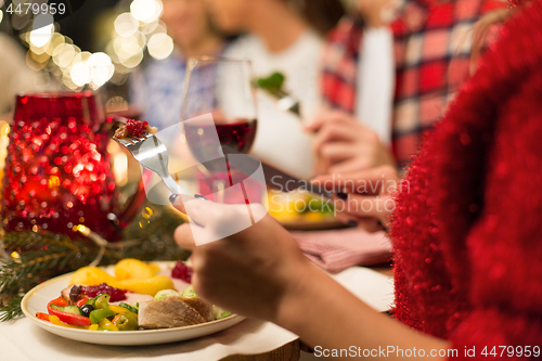 Image of close up of friends having christmas dinner