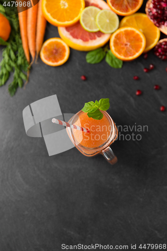 Image of mason jar glass of fruit juice on slate table top