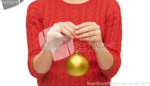 Image of close up of woman in sweater with christmas ball