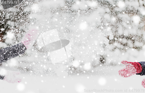 Image of happy friends playing with snow in winter