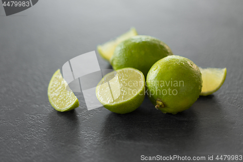 Image of close up of limes on slate table top