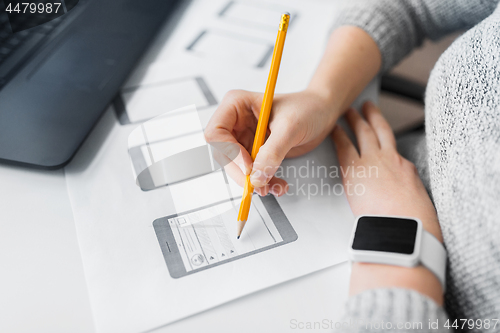 Image of web designer working on user interface at office