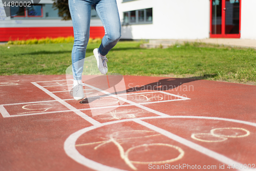 Image of Legs of kids jumps hopscotch