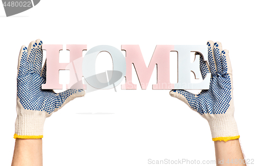 Image of Hands holding Home word