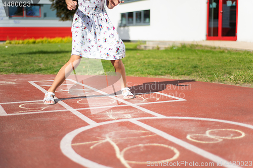 Image of Legs of kids jumps hopscotch