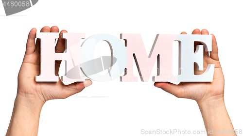 Image of Hands holding Home word