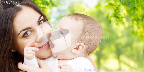 Image of mother with baby over green natural background