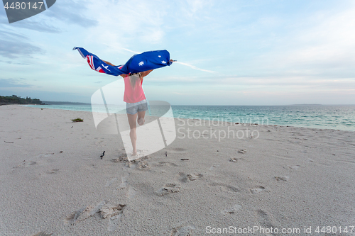 Image of Woman leaping into the air with Australian Flag