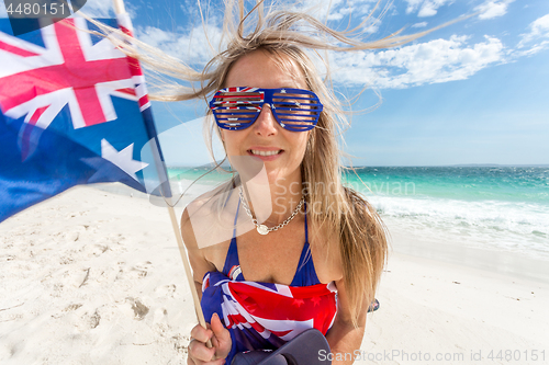 Image of Australian supporter or fan waving flag on the beach