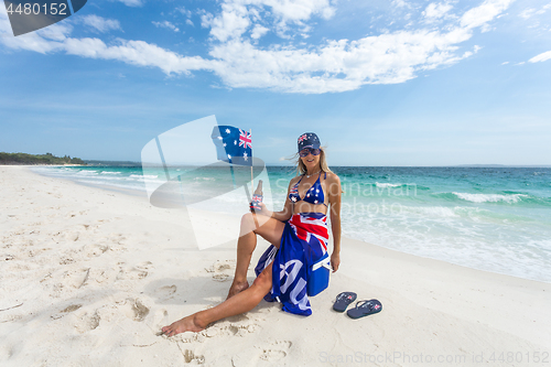 Image of True Blue Fair Dinkum Australian girl laid back on the beach