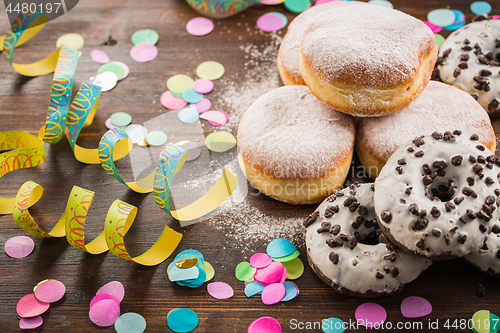 Image of Krapfen, Berliner or  donuts with streamers and confetti