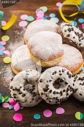 Image of Krapfen, Berliner or  donuts with streamers and confetti
