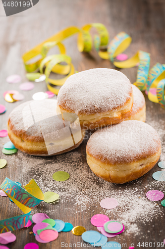 Image of Krapfen, Berliner or  donuts with streamers and confetti