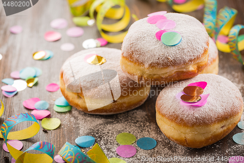 Image of Krapfen, Berliner or  donuts with streamers and confetti