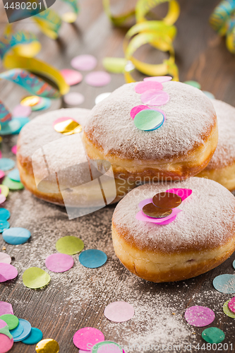 Image of Krapfen, Berliner or  donuts with streamers and confetti