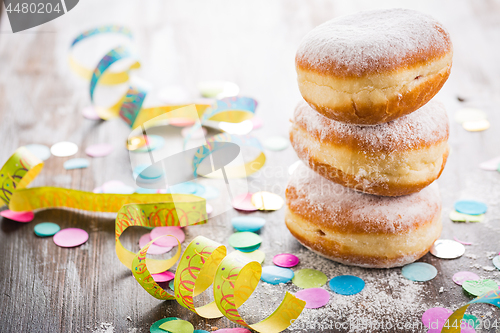 Image of Krapfen, Berliner or  donuts with streamers and confetti