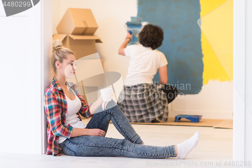 Image of young couple doing home renovations