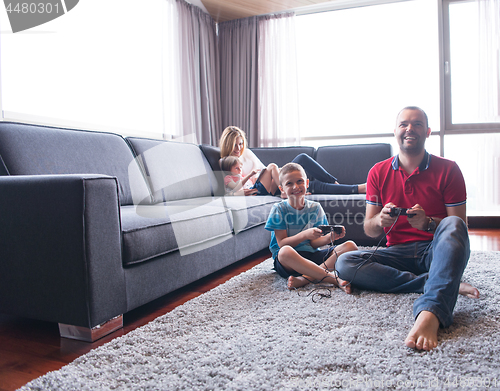 Image of Happy family playing a video game