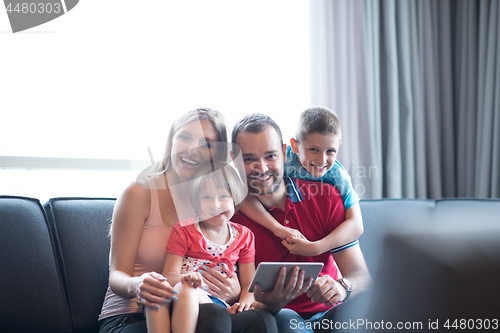 Image of happy young couple spending time with kids